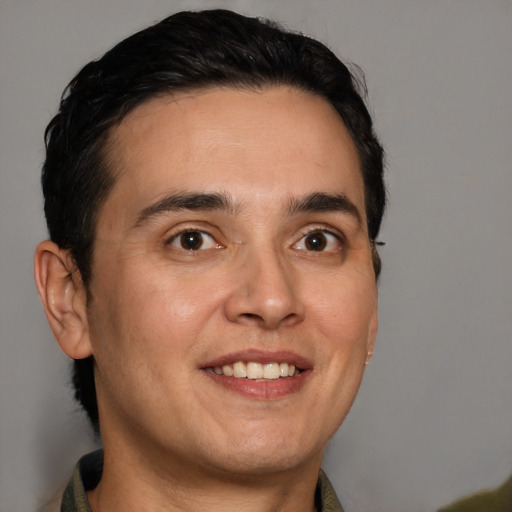 Joyful white young-adult male with short  black hair and brown eyes