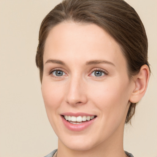 Joyful white young-adult female with short  brown hair and green eyes