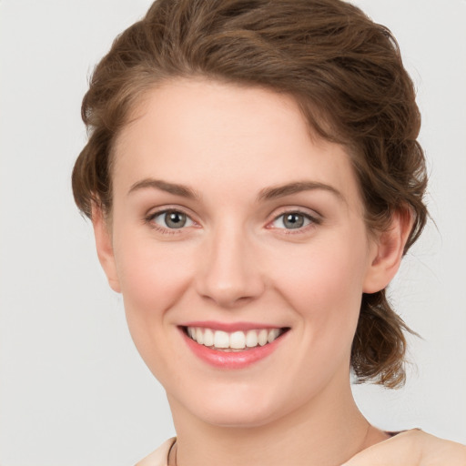 Joyful white young-adult female with medium  brown hair and green eyes