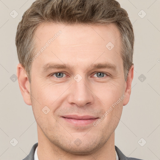 Joyful white adult male with short  brown hair and grey eyes