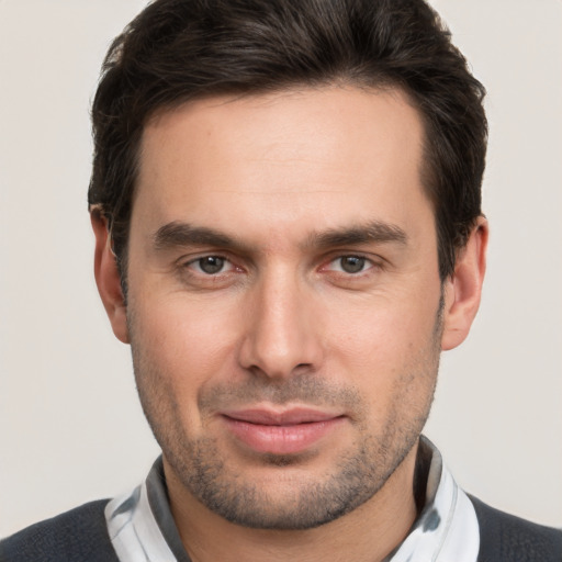 Joyful white young-adult male with short  brown hair and brown eyes