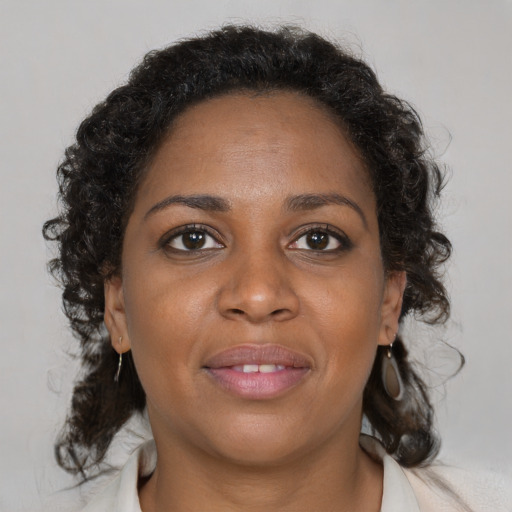 Joyful black young-adult female with medium  brown hair and brown eyes