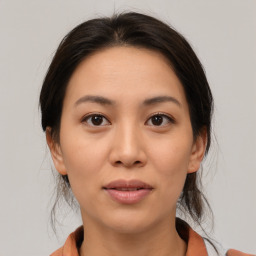 Joyful asian young-adult female with medium  brown hair and brown eyes