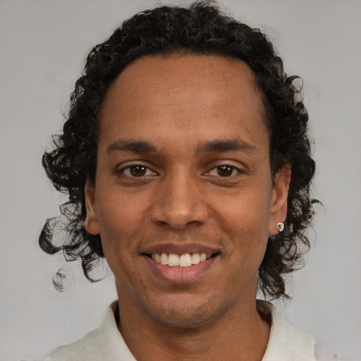 Joyful black young-adult male with short  brown hair and brown eyes