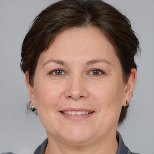 Joyful white adult female with medium  brown hair and brown eyes