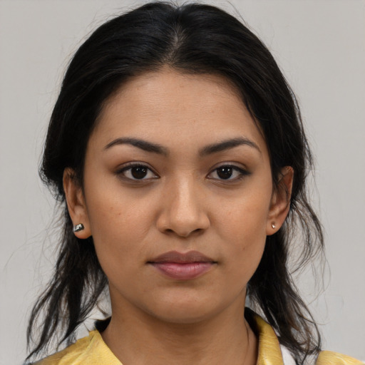Joyful latino young-adult female with medium  brown hair and brown eyes
