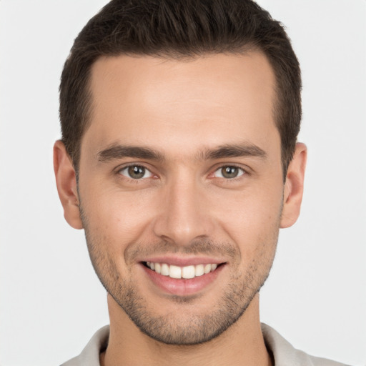 Joyful white young-adult male with short  brown hair and brown eyes