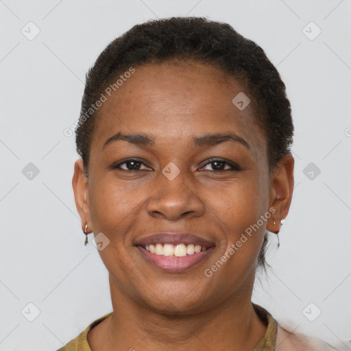 Joyful black adult female with short  brown hair and brown eyes