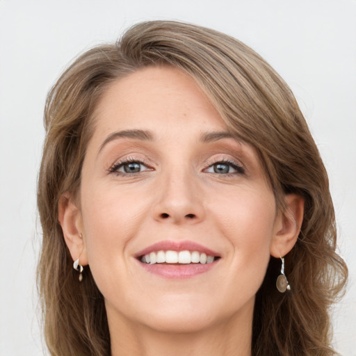 Joyful white young-adult female with long  brown hair and grey eyes