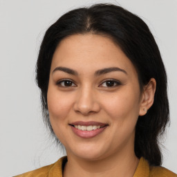 Joyful latino young-adult female with medium  brown hair and brown eyes