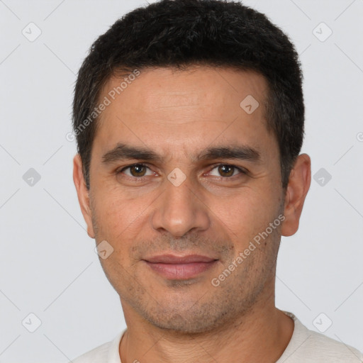 Joyful white young-adult male with short  black hair and brown eyes