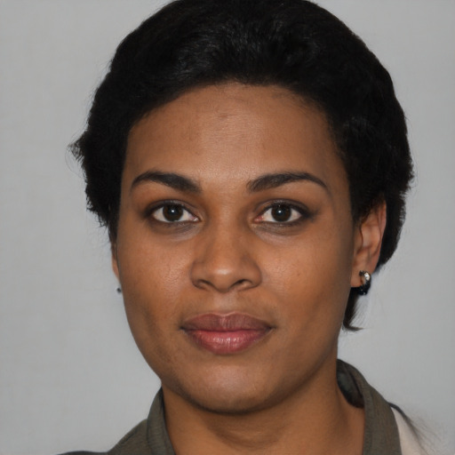 Joyful black young-adult female with short  black hair and brown eyes