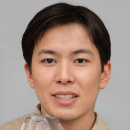 Joyful asian young-adult male with short  brown hair and brown eyes