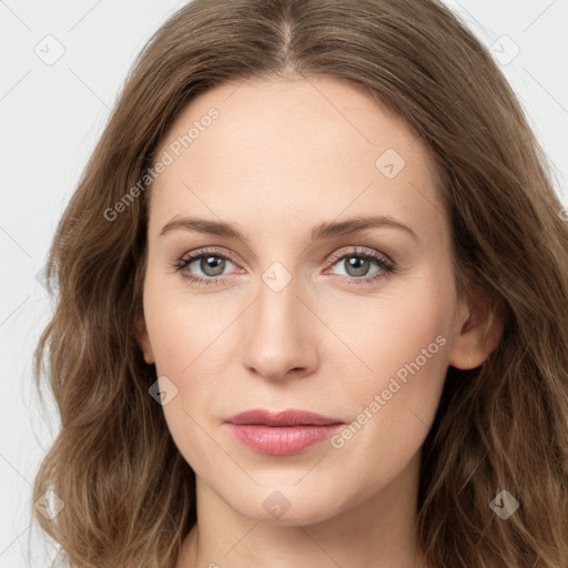 Joyful white young-adult female with long  brown hair and green eyes