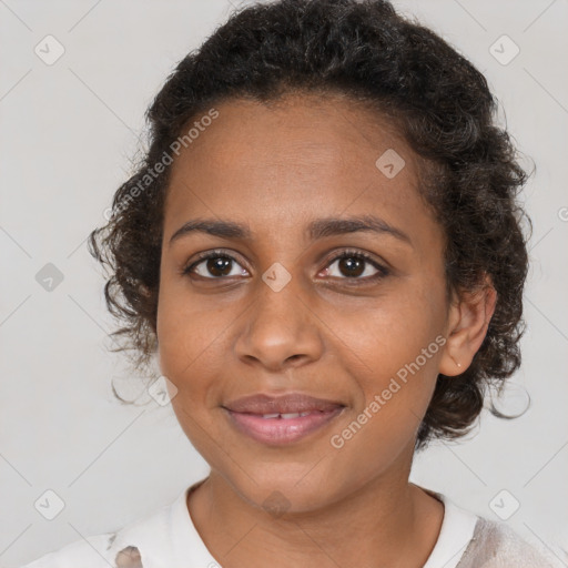 Joyful black young-adult female with short  brown hair and brown eyes