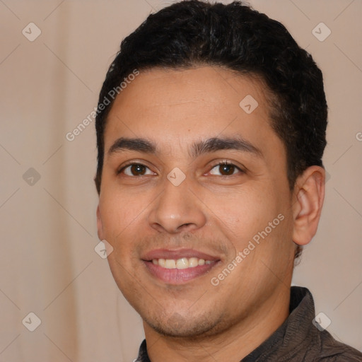 Joyful white young-adult male with short  black hair and brown eyes