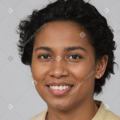 Joyful black young-adult female with short  brown hair and brown eyes