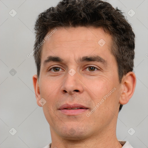 Joyful white adult male with short  brown hair and brown eyes