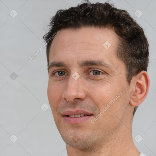 Joyful white adult male with short  brown hair and brown eyes