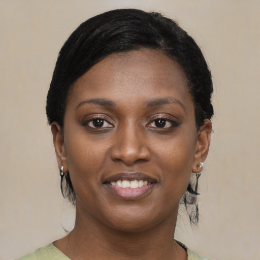 Joyful black young-adult female with medium  black hair and brown eyes