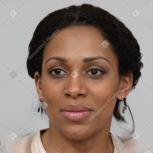 Joyful black adult female with short  black hair and brown eyes