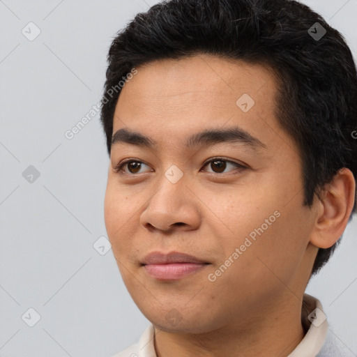 Joyful asian young-adult male with short  black hair and brown eyes