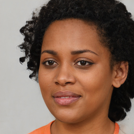 Joyful black young-adult female with medium  black hair and brown eyes