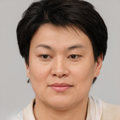 Joyful asian young-adult female with short  brown hair and brown eyes