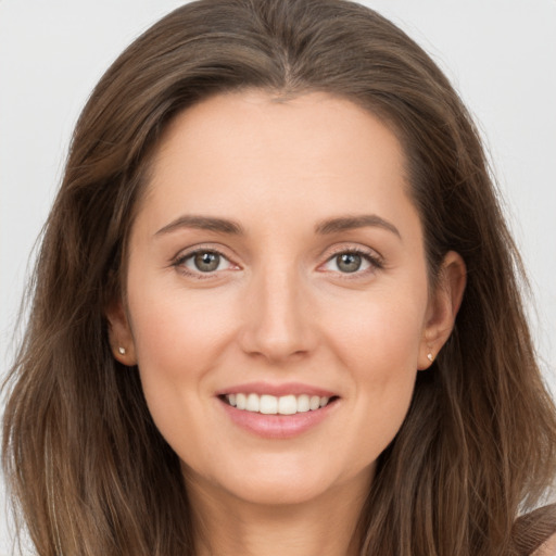 Joyful white young-adult female with long  brown hair and brown eyes