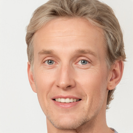 Joyful white adult male with short  brown hair and grey eyes