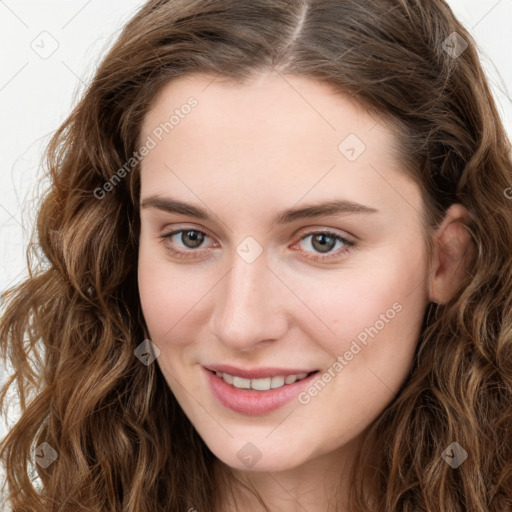 Joyful white young-adult female with long  brown hair and green eyes