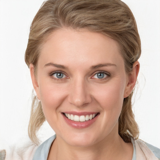 Joyful white young-adult female with medium  brown hair and blue eyes