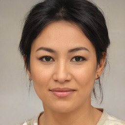 Joyful asian young-adult female with medium  brown hair and brown eyes