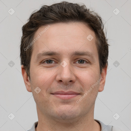 Joyful white adult male with short  brown hair and grey eyes