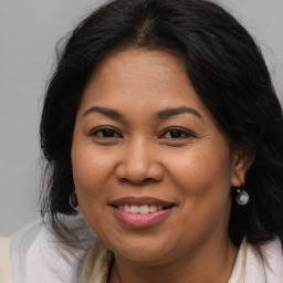 Joyful white adult female with long  brown hair and brown eyes