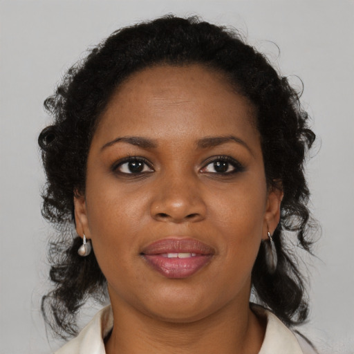 Joyful black young-adult female with medium  brown hair and brown eyes
