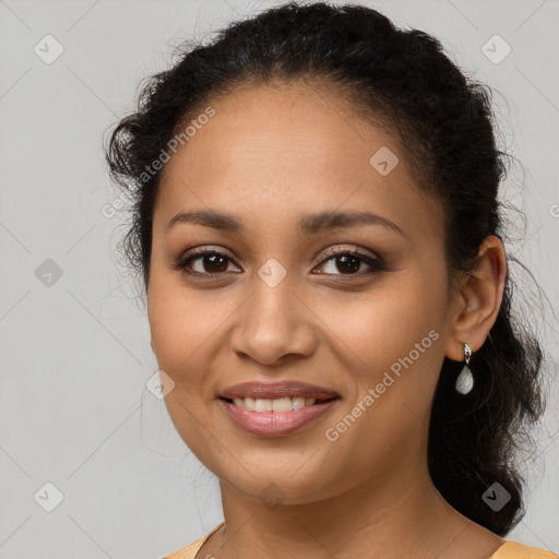 Joyful latino young-adult female with long  brown hair and brown eyes