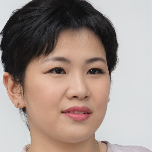 Joyful asian young-adult female with short  brown hair and brown eyes