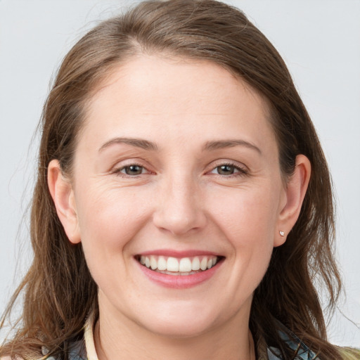 Joyful white young-adult female with long  brown hair and grey eyes