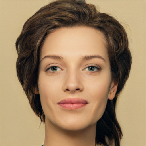 Joyful white young-adult female with medium  brown hair and green eyes