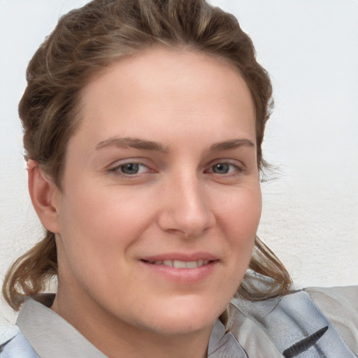 Joyful white young-adult female with medium  brown hair and blue eyes