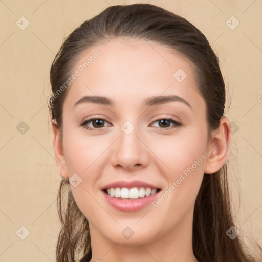 Joyful white young-adult female with long  brown hair and brown eyes