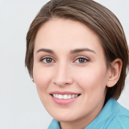 Joyful white young-adult female with medium  brown hair and blue eyes