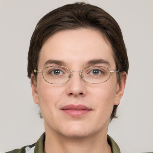 Joyful white young-adult female with short  brown hair and grey eyes