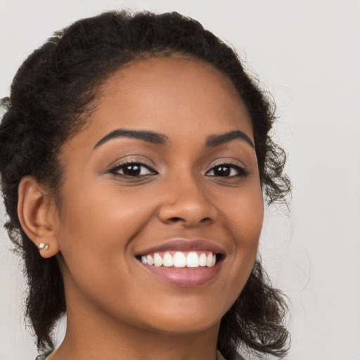 Joyful latino young-adult female with long  brown hair and brown eyes