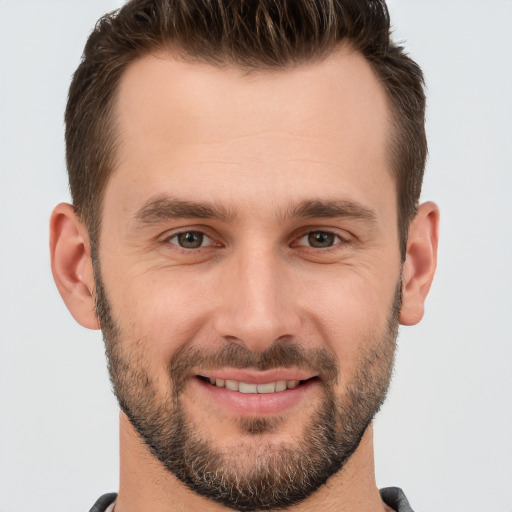 Joyful white young-adult male with short  brown hair and brown eyes