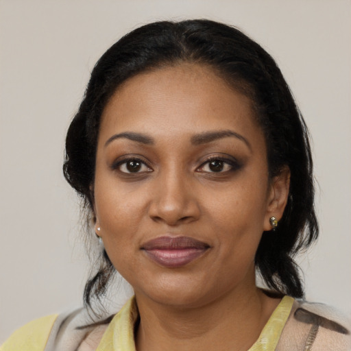 Joyful black young-adult female with medium  black hair and brown eyes