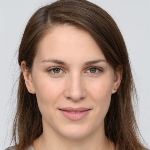 Joyful white young-adult female with long  brown hair and grey eyes