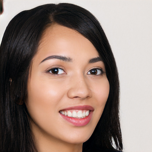 Joyful latino young-adult female with long  black hair and brown eyes