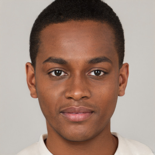 Joyful black young-adult male with short  brown hair and brown eyes